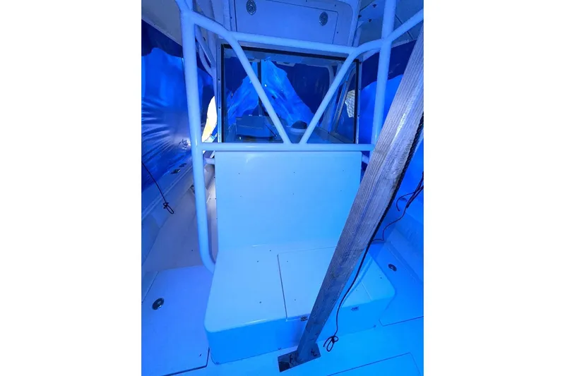 Slide: The Image of 2005 Regulator 32 Forward Seating boat interior with blue lighting and structural support. - 13