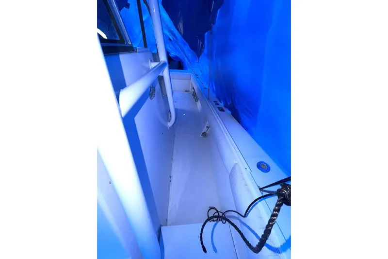 Slide: The Image of 2005 Regulator 32 Forward Seating boat interior under blue cover. - 15