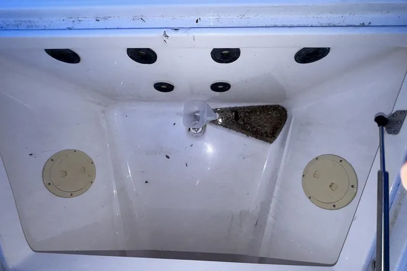Slide: The Image of 2005 Regulator 32 Forward Seating boat compartment with drainage and storage features. - 16