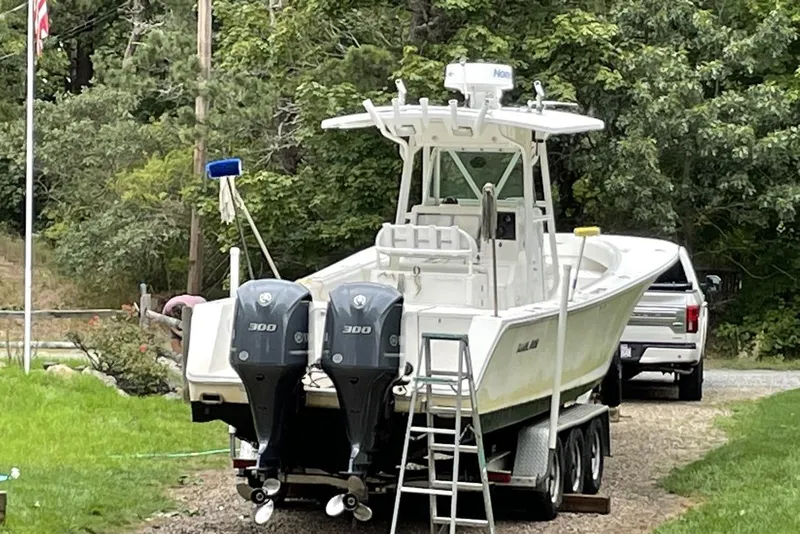 Slide: The Image of 2005 Regulator 32 Forward Seating boat on trailer with twin 300 engines. - 2