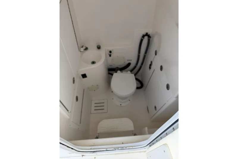 Slide: The Image of 2005 Regulator 32 Forward Seating boat bathroom with toilet and sink. - 29