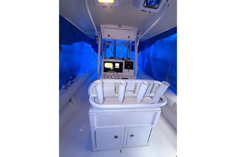 Slide: The Image of 2005 Regulator 32 Forward Seating boat interior with blue canopy and control panel. - 4