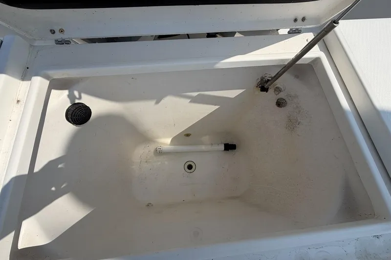 Slide: The Image of Open storage compartment on a 2005 Regulator 32 Forward Seating boat. - 24