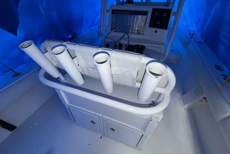 Slide: The Image of 2005 Regulator 32 Forward Seating boat interior with rod holders and control panel. - 6