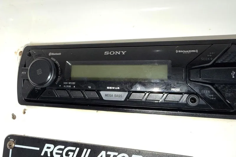 Slide: The Image of Sony DSX-M55BT stereo on a 2005 Regulator 32 Forward Seating boat dashboard. - 8