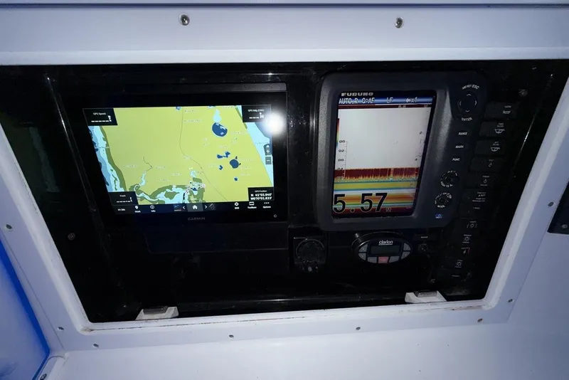 Slide: The Image of 2005 Regulator 32 Forward Seating boat dashboard with navigation and sonar displays. - 9