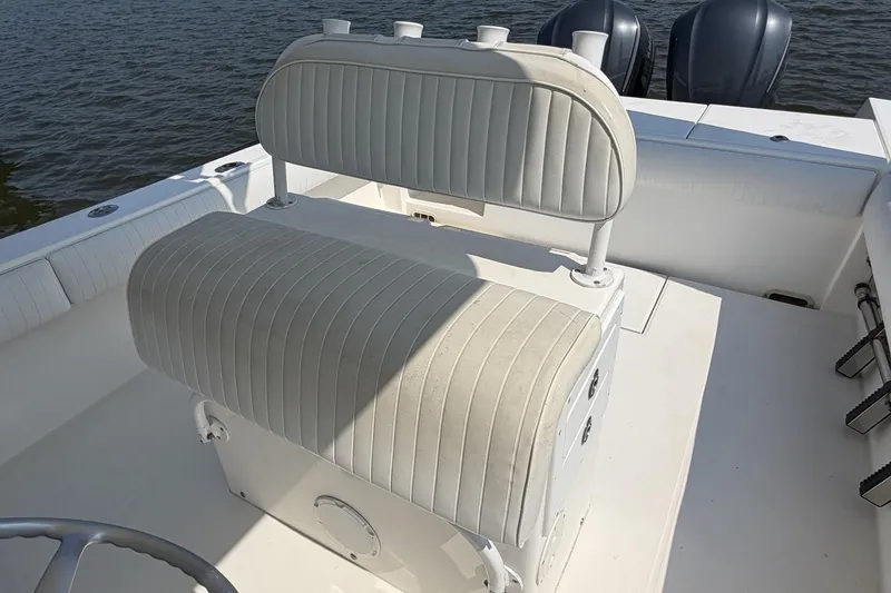 Slide: The Image of 2005 Regulator 32 Forward Seating boat interior with dual engines and cushioned seating. - 19