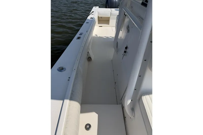 Slide: The Image of 2005 Regulator 32 Forward Seating boat interior, showcasing sleek white deck and seating. - 28