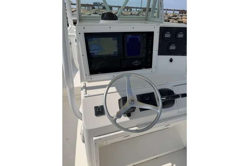 Slide: The Image of 2005 Regulator 32 Forward Seating boat console with steering wheel and navigation display. - 23