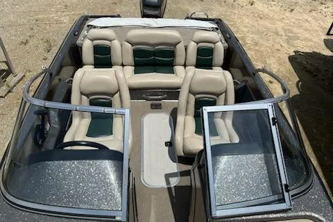 Slide: The Image of 1998 Tracker Targa 185 Sport boat interior with beige and green seating. - 18