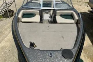 Slide: The Image of 1998 Tracker Targa 185 Sport boat with open seating and windshield, parked on gravel. - 6