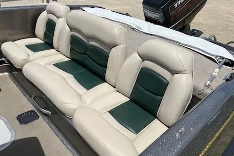 Slide: The Image of 1998 Tracker Targa 185 Sport boat with beige and green seating. - 8