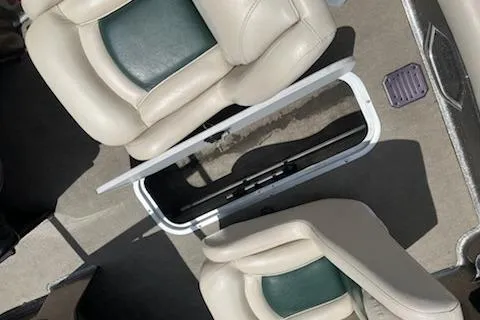 Slide: The Image of 1998 Tracker Targa 185 Sport boat interior with beige and green seating. - 9