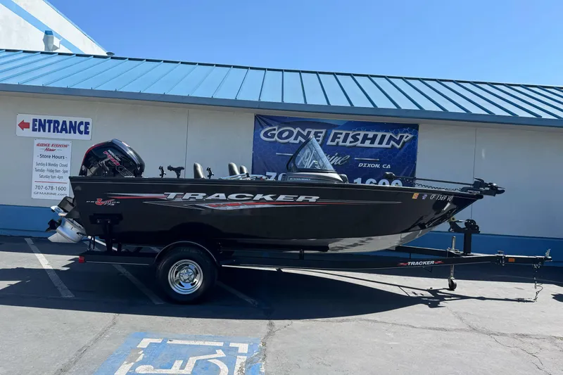 Slide: The Image of 2021 Tracker Pro Guide V-175 Combo boat dashboard with steering wheel and Lowrance fish finder. - 12