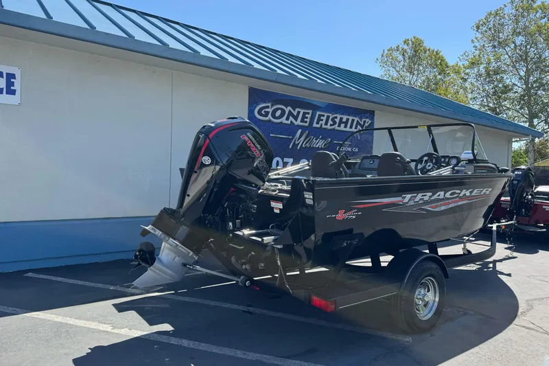 Slide: The Image of 2021 Tracker Pro Guide V-175 Combo boat displayed outdoors, featuring a powerful outboard motor. - 4