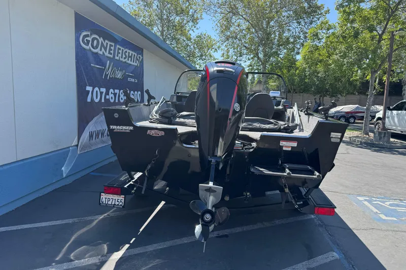 Slide: The Image of 2021 Tracker Pro Guide V-175 Combo boat parked at dealership, rear view. - 5