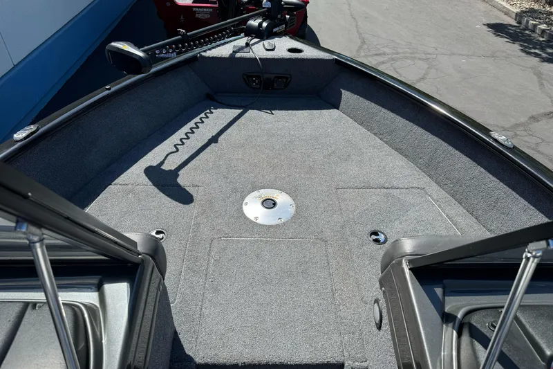 Slide: The Image of 2021 Tracker Pro Guide V-175 Combo boat interior with carpeted deck and trolling motor. - 8
