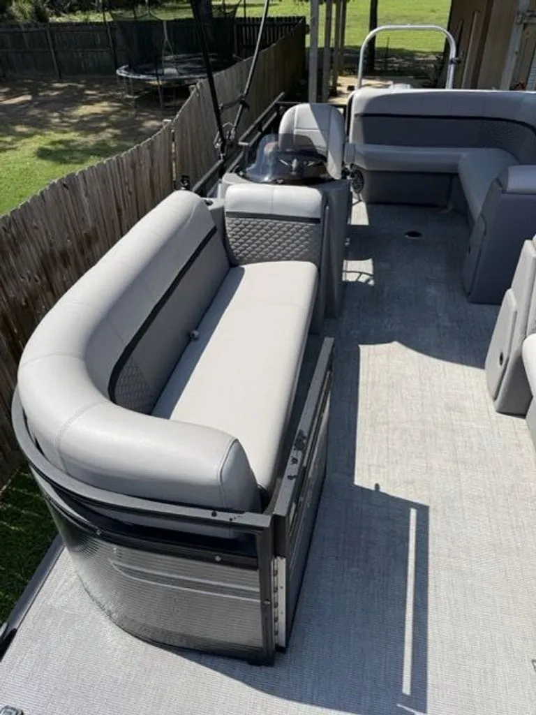 Slide: The Image of 2022 Quest Lanai pontoon boat with gray seating and modern design. - 11