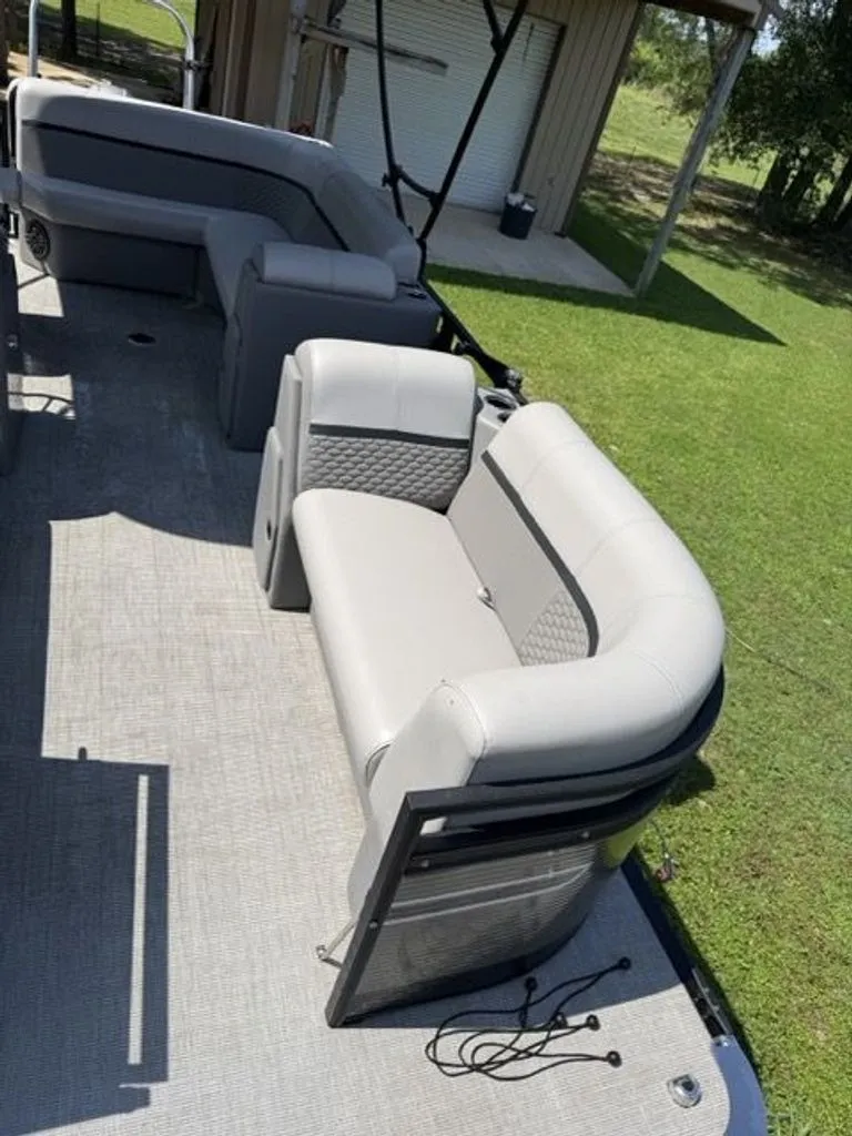 Slide: The Image of Quest Lanai 2022 pontoon boat with gray seating outdoors. - 12