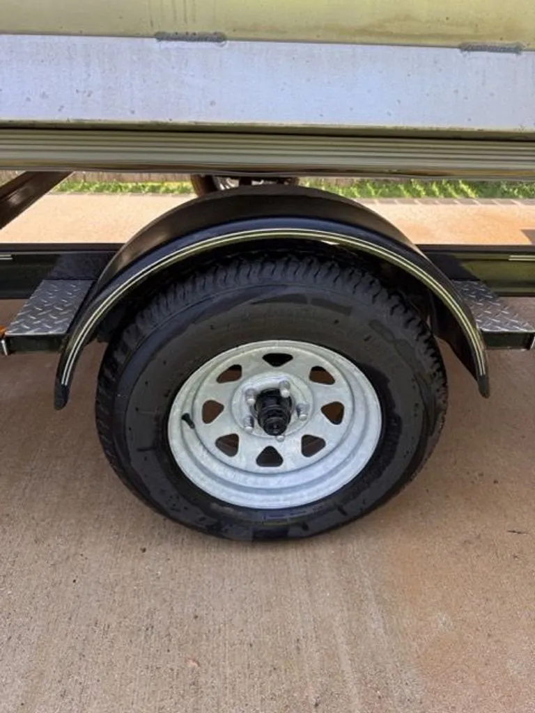 Slide: The Image of Close-up of a Quest Lanai 2022 trailer wheel on concrete. - 29