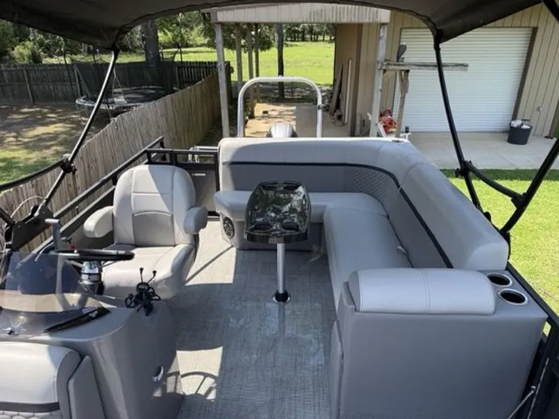 Slide: The Image of Interior of a 2022 Quest Lanai pontoon boat with gray seating. - 3
