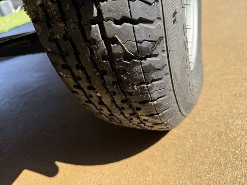 Slide: The Image of Close-up of a worn tire on a 2022 Quest Lanai. - 31