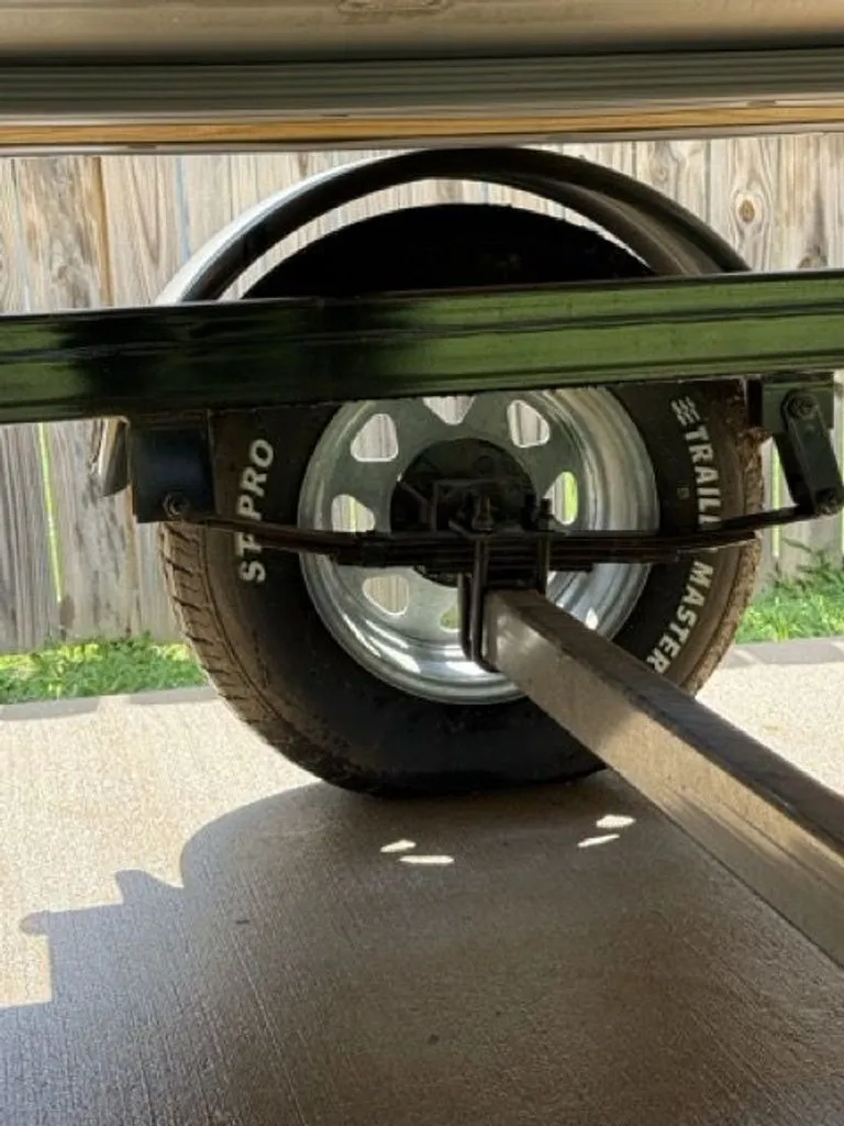 Slide: The Image of Close-up of a Quest Lanai 2022 trailer tire on concrete. - 34
