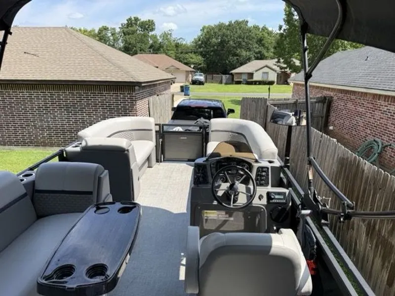Slide: The Image of Interior view of a 2022 Quest Lanai pontoon boat in a backyard. - 4