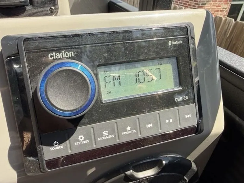 Slide: The Image of Clarion car stereo in 2022 Quest Lanai, displaying FM 105.7. - 7