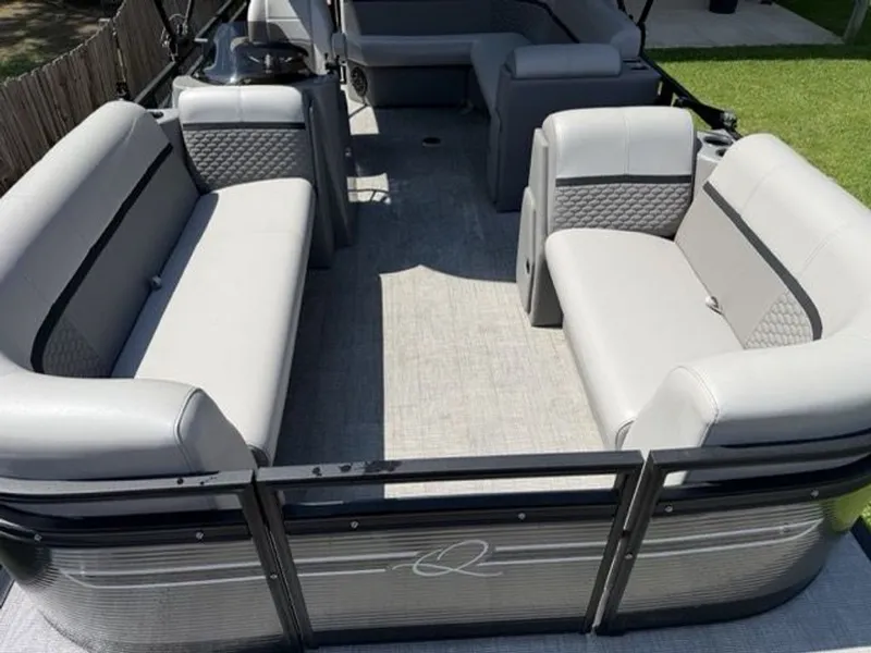 Slide: The Image of Interior of a 2022 Quest Lanai pontoon boat with gray seating. - 9
