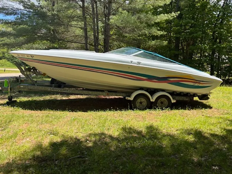 The Image of 1995 Baja 272 boat on trailer in grassy area. - 0
