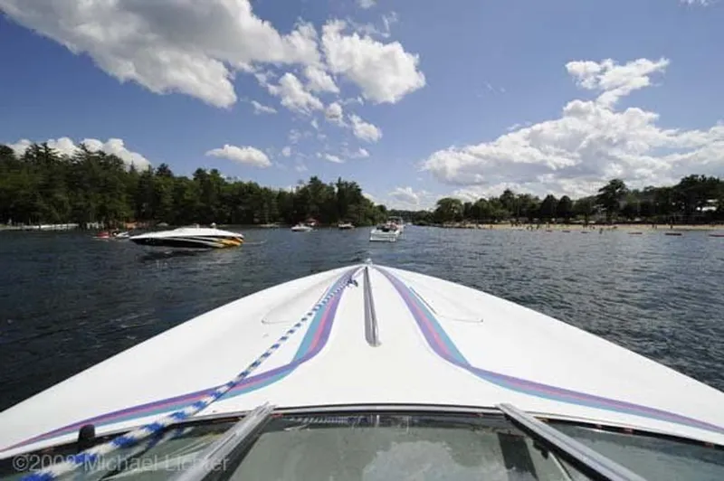 Slide: The Image of 1995 Baja 272 boat on a lake under a blue sky. - 2
