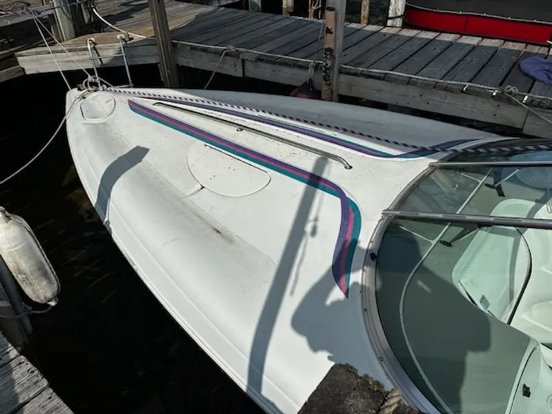 Slide: The Image of 1995 Baja 272 boat docked with colorful stripes. - 3