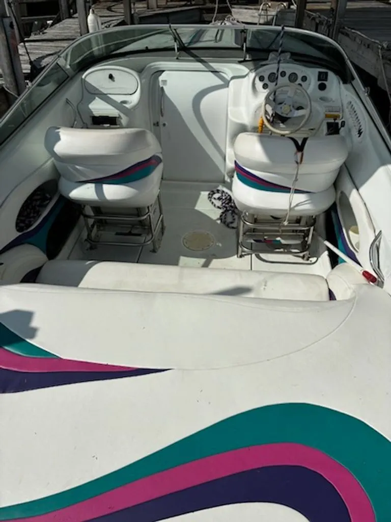 Slide: The Image of Interior of a 1995 Baja 272 boat with colorful seats. - 4
