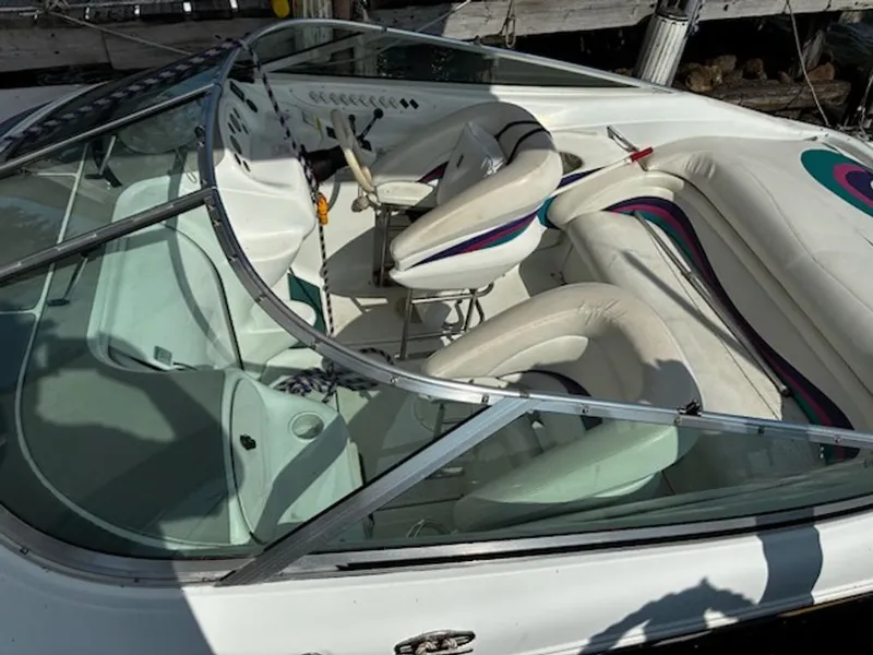 Slide: The Image of Interior of a 1995 Baja 272 boat with white seating. - 5