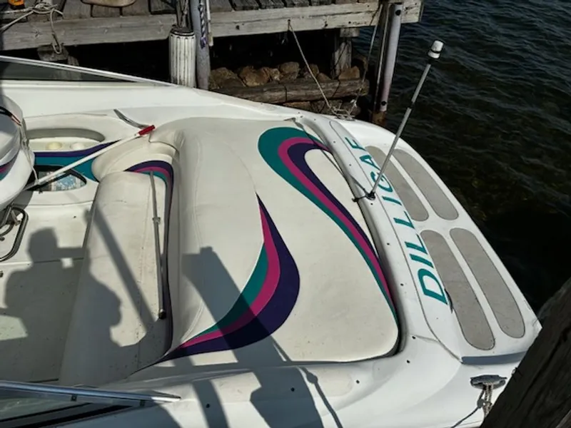 Slide: The Image of 1995 Baja 272 boat docked with colorful design. - 7