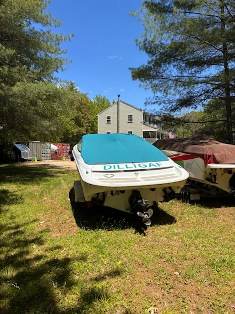 Slide: The Image of 1995 Baja 272 boat with cover parked in yard. - 9