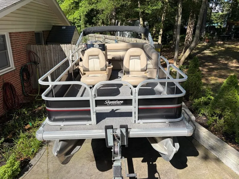 The Image of 2016 Sun Tracker BB pontoon boat parked in a garden. - 0