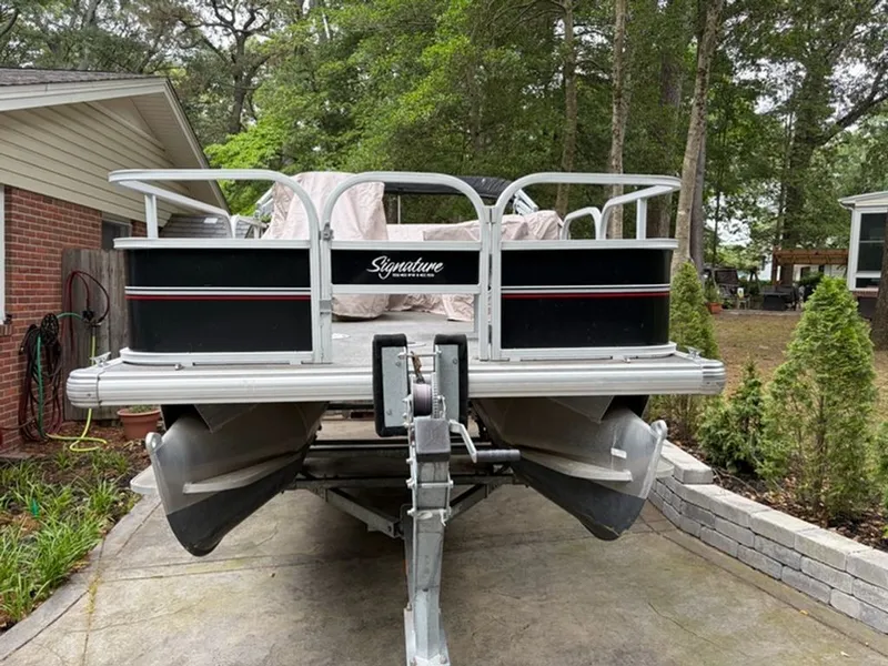 Slide: The Image of 2016 Sun Tracker BB pontoon boat on trailer in backyard. - 2