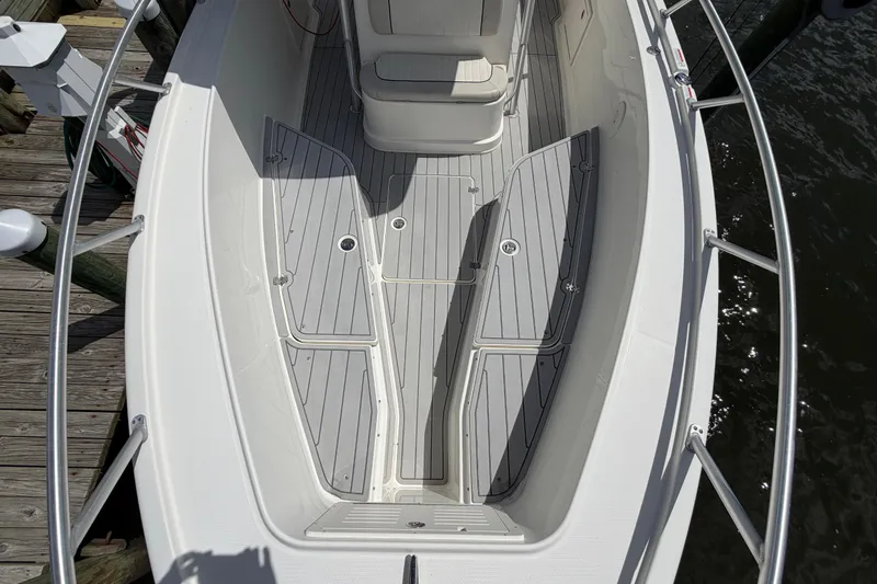 Slide: The Image of 2017 Mako 284 Center Console boat with sleek deck design and seating. - 23