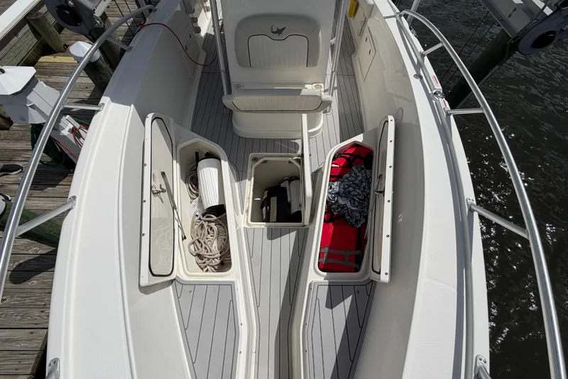 Slide: The Image of 2017 Mako 284 Center Console boat deck with open storage compartments and nautical gear. - 24