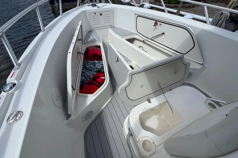 Slide: The Image of 2017 Mako 284 Center Console boat interior with open storage compartments. - 26