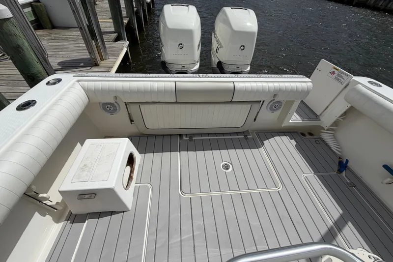 Slide: The Image of 2017 Mako 284 Center Console boat with twin outboard engines at dock. - 30
