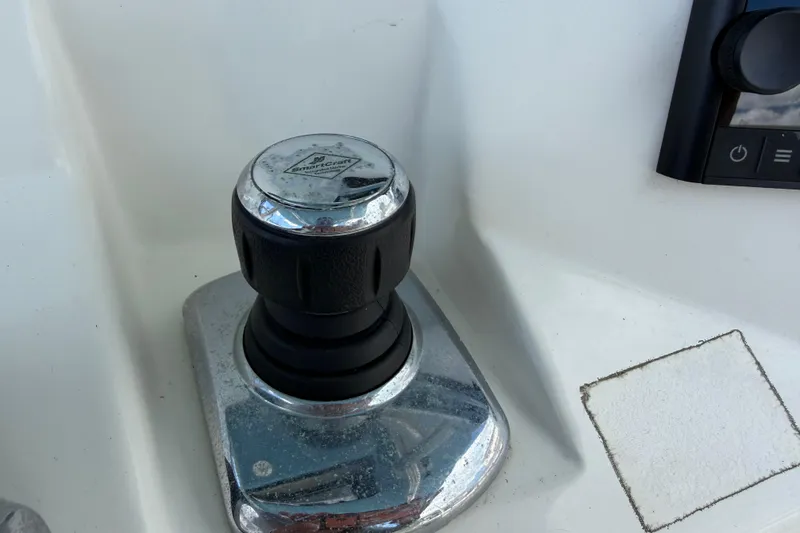 Slide: The Image of Close-up of a 2017 Mako 284 Center Console boat control knob. - 32