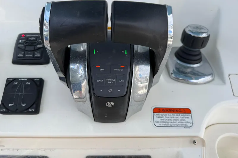 Slide: The Image of Close-up of 2017 Mako 284 Center Console boat controls and throttle system. - 33