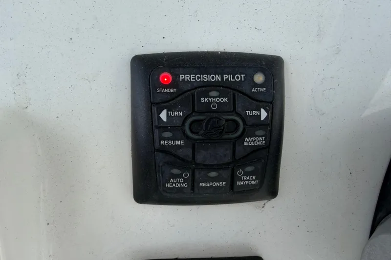 Slide: The Image of Control panel of a 2017 Mako 284 Center Console boat with Precision Pilot system. - 34