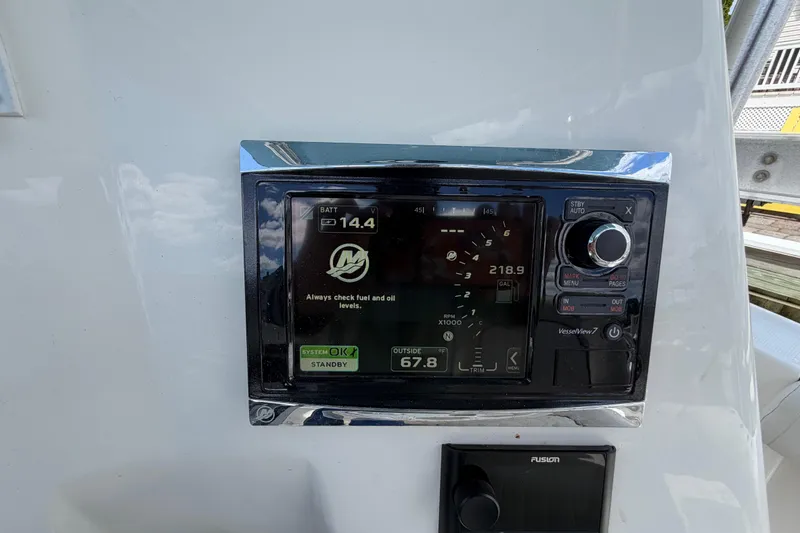 Slide: The Image of Close-up of a 2017 Mako 284 Center Console boat's control panel display. - 35