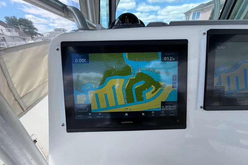Slide: The Image of Garmin navigation display on 2017 Mako 284 Center Console boat, showing coastal map. - 36