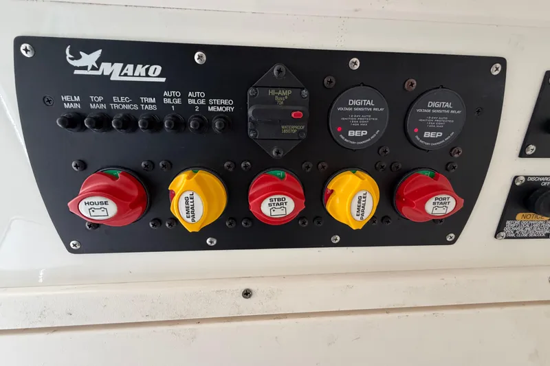 Slide: The Image of Control panel of a 2017 Mako 284 Center Console boat with switches and relays. - 41