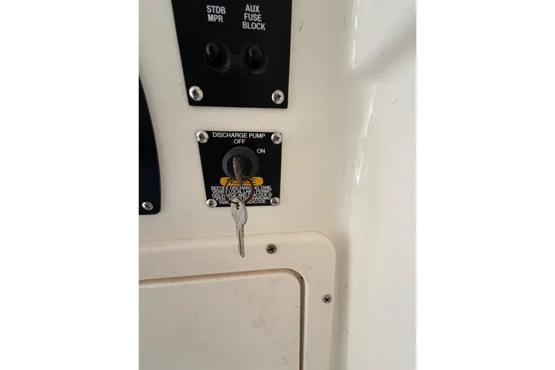 Slide: The Image of Control panel of a 2017 Mako 284 Center Console boat with discharge pump switch. - 42